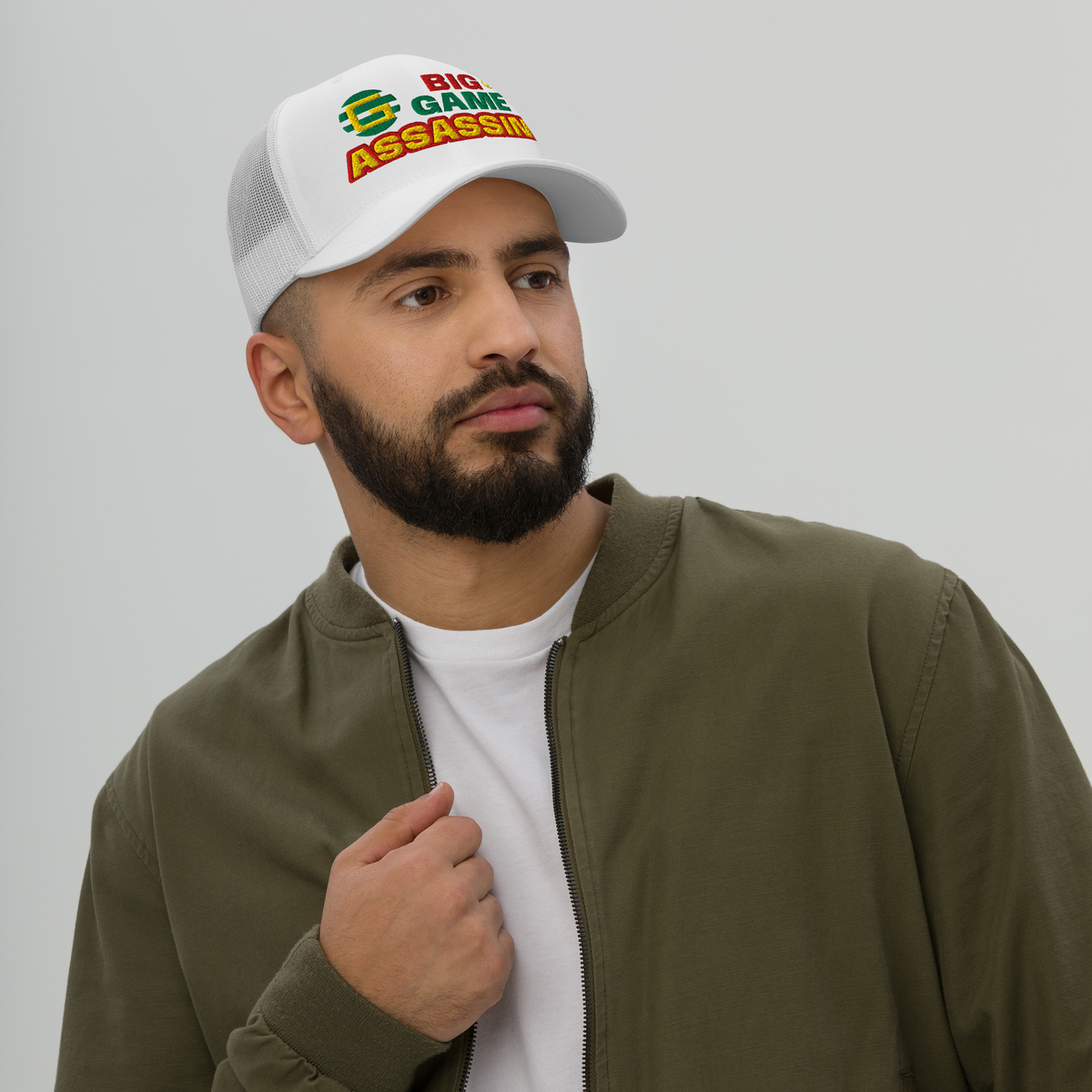 BIG GAME ASSASSIN® Triple C's Trucker Cap (layered text). Red, green and yellow design. Available in a variety of colours. One size.